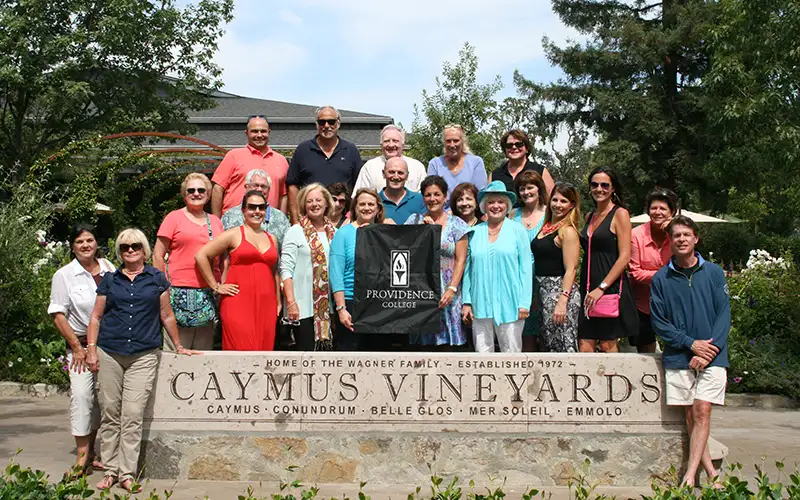 Alumni group photo traveling to Caymus Vineyard