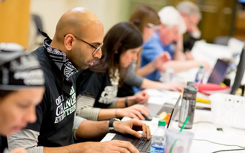 alumni relation volunteers on computers for friars give giving tracking