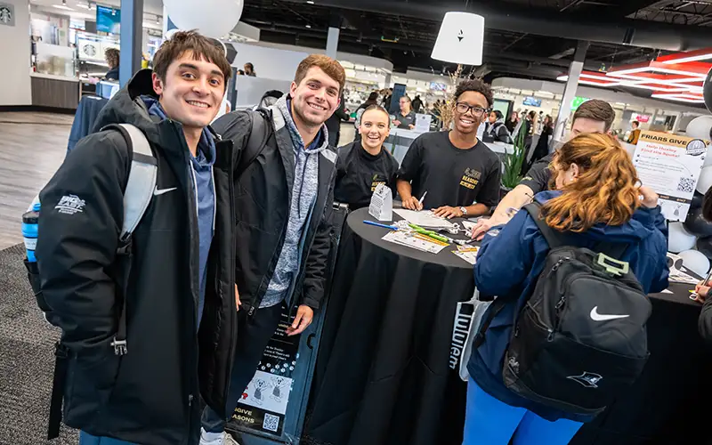 students smiling at friars give events